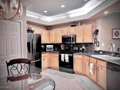 Eat-In Kitchen with wood cabinets, granite counters, back splash, stainless appliances and new lighting.