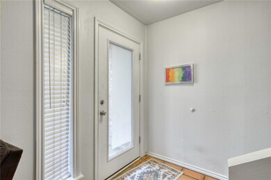 Doorway featuring light tile patterned flooring