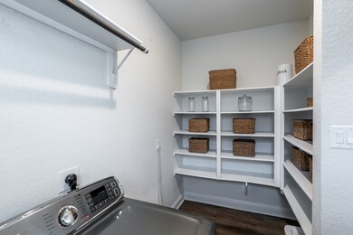 A spacious utility room has added character and offers ample space for additional storage and appliances.