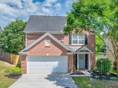 Great curb appeal! This charming brick home offers a large shade tree and well-maintained landscaping