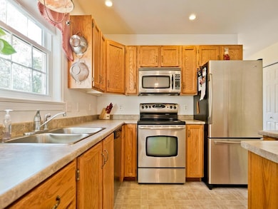 Sunny kitchen with oak cabinets,...