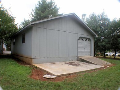 Rear of detached garage has ramp for easy storage.