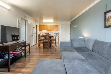 Living room featuring ornamental molding and wood finished floors