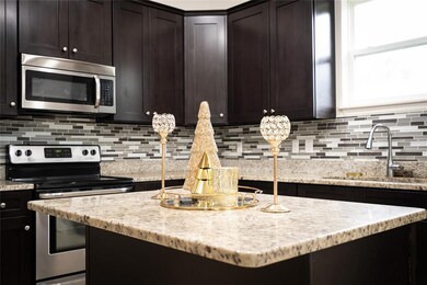 Large granite topped island makes this kitchen a chef's dream!