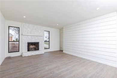 Living room with new flooring and paint, stone fir