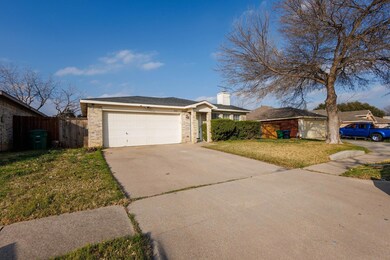 Ranch-style house with a garage and a front yard