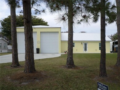 FRONT WITH PINE TREES BACK HAS LARGE TREE