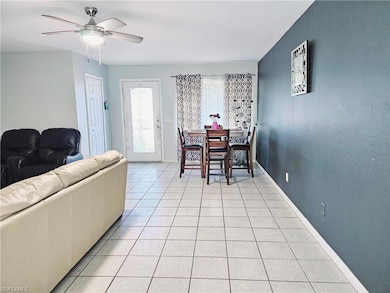 Dining room featuring a ceiling fan, light tile patterned floors, and baseboards