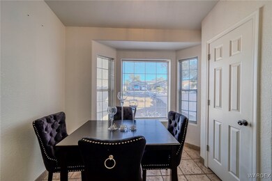 Dining space featuring light tile patterned floors