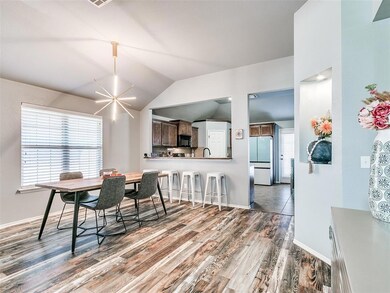 Dining room with updated lighting and large pictur