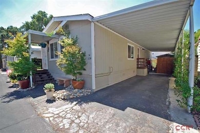 Extra long driveway and covered carport and patio.