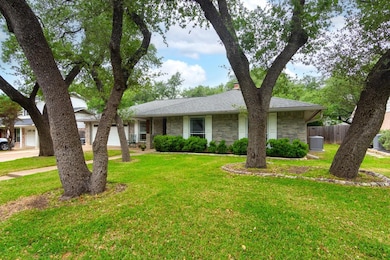 Ranch-style home with stone siding, cooling unit,