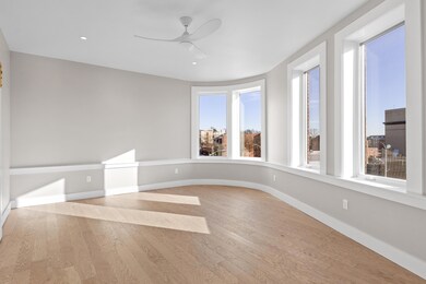 Curved window wall in oversized bedroom