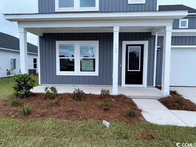 View of exterior entry featuring a garage and a po