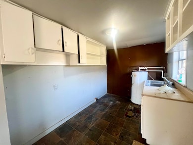 Kitchen with sink and white cabinetry