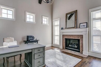Cozy office with fireplace and lots of natural light.