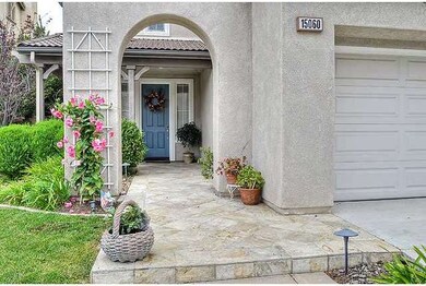 Tiled entry and arched facade are accented with co