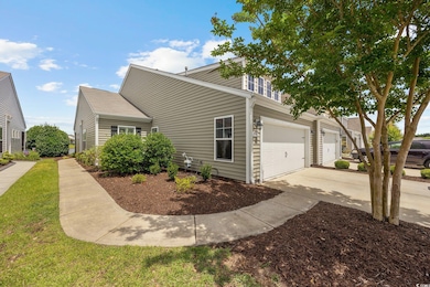 View of front of home with driveway and an attache