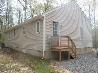 Exterior Back - The home has a side stoop leading 
