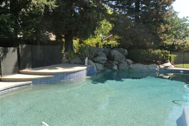 Pebble Tech pool with large rock waterfall