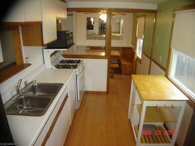 Bright eat-in kitchen has laminate flooring, a bre