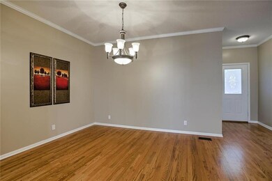 Formal dining room with gleaming wood floors.