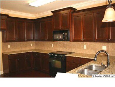Your gourmet kitchen has abundant cabinet space, granite countertops, smooth top range/oven...