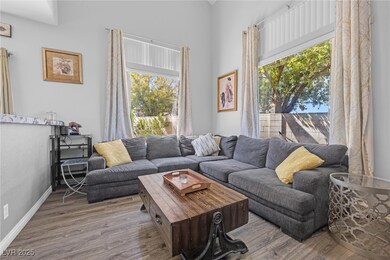 Living area with baseboards and wood finished floo