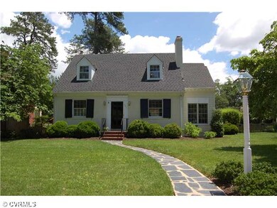 Exterior Front - Charming painted brick with lush 