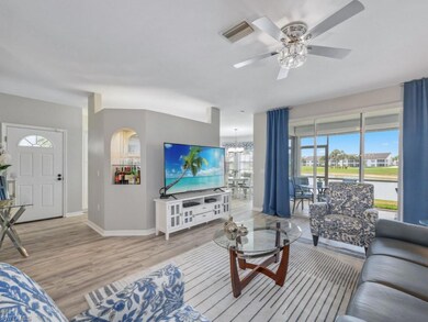 Living area with baseboards, ceiling fan with nota