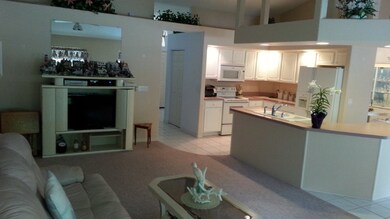 Family room dressed in a neutral decor,features pl