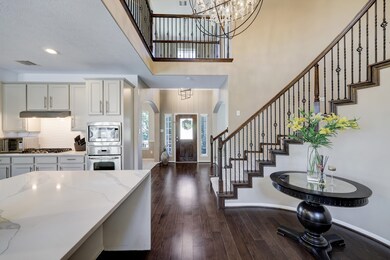 Stunning view of the chandelier, and the beautifully remodeled kitchen.