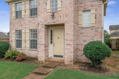 View of exterior entry featuring brick siding