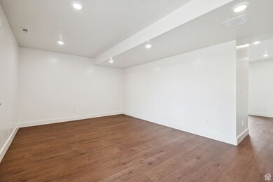 Unfurnished room with recessed lighting and dark wood-style flooring