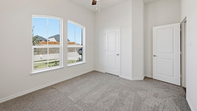 Unfurnished bedroom with light carpet and ceiling fan