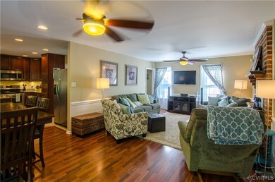 Family room with ceiling fan, chair rail, Brick fi