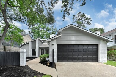 Freshly painted exterior with black garage and mat