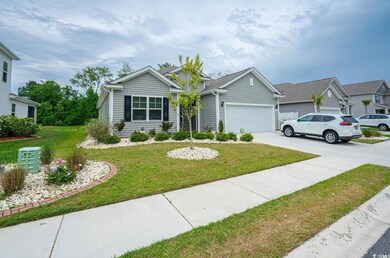 View of front of house featuring a garage, concret
