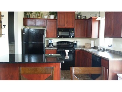 Kitchen with granite counters and SS appliances.