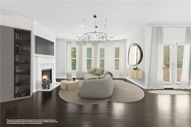 Living room featuring a chandelier, wood finished floors, a high end fireplace, and baseboards