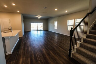 Foyer with ceiling fan, dark wood-type flooring, and sink