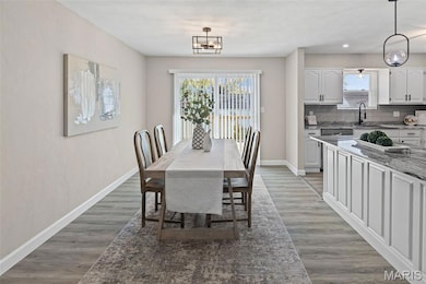 Dining area featuring light wood-style flooring and a chandelier