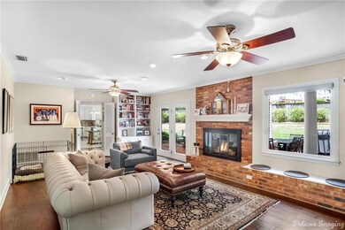 The family room has ceiling fans, built-ins, a won