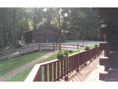 View of fenced in backyard and two car garage