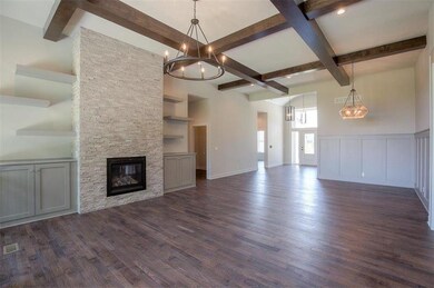 Great Room with hardwoods and beams! Photos are of