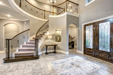 A custom double alder, glass, and iron door greets
