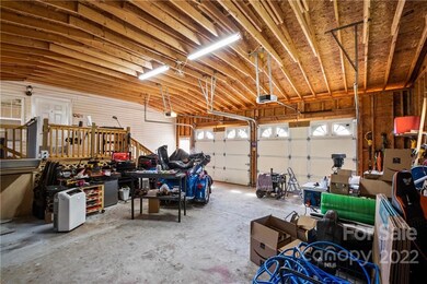 Oversized garage with electric lift up to platform and entrance into home