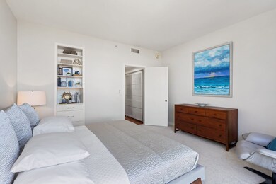 Bedroom with built-in shelving and automatic solar