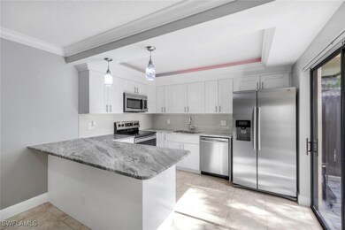 Kitchen with stainless steel appliances, a sink, b