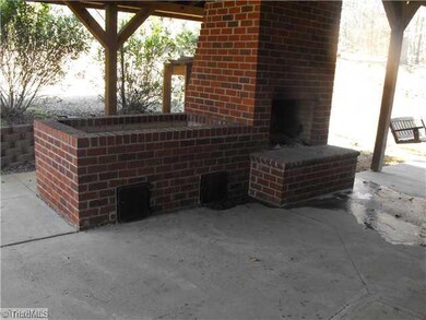 Exterior Back. BBQ Pit and Outside Fire Place
